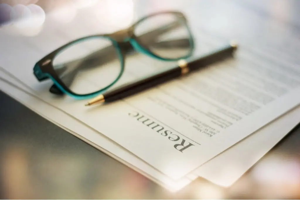 Resume beside pen and glasses